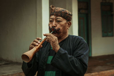 Man playing traditional wind instrument