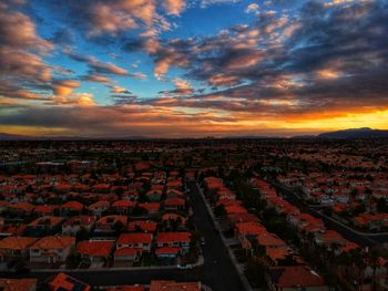 Aerial view of town against cloudy sky