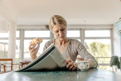 Woman at home having breakfast