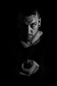 Portrait of mature man against black background