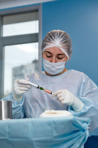 Close-up of doctor holding thermometer