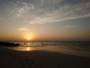 Scenic view of beach against sky during sunset