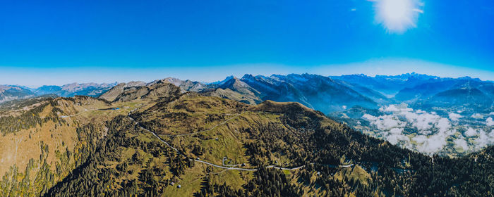 Scenic view of mountains against blue sky