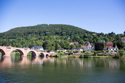 Arch bridge over river against sky