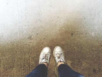 Low section of woman standing on tiled floor