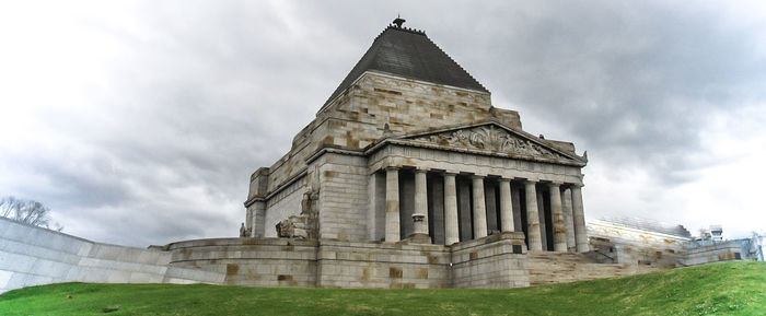 Low angle view of building against cloudy sky