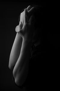 Close-up of human hand against black background