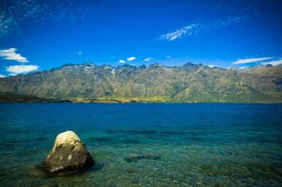 Scenic view of lake and mountains against sky