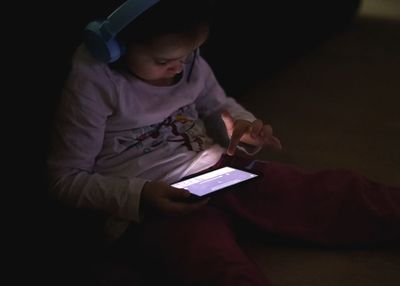 Midsection of boy using mobile phone