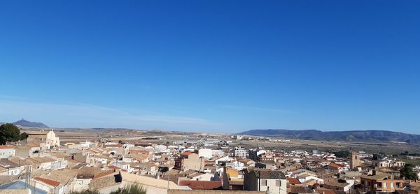 High angle view of townscape against blue sky