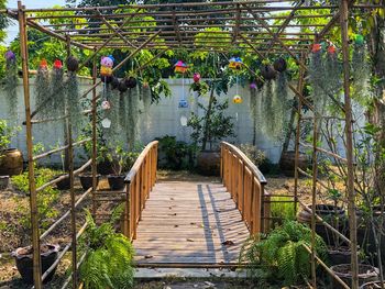 Wooden footbridge against plants and bridge
