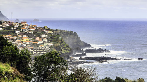 Scenic view of buildings by sea