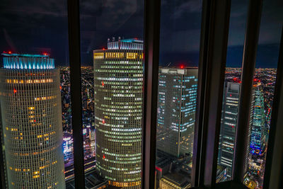 Illuminated modern buildings in city at night