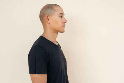 Young man standing against white background