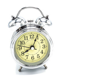 Close-up of clock over white background