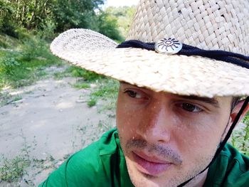 Close-up portrait of young man wearing hat