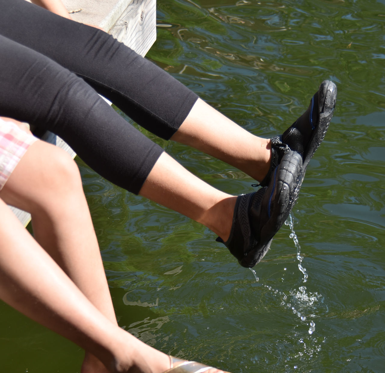 LOW SECTION OF WOMAN LEGS IN LAKE