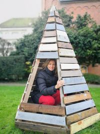 Portrait of woman sitting in wooden structure