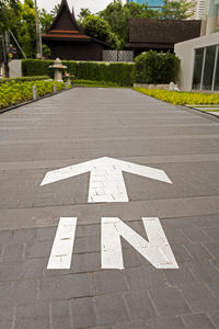 Arrow sign on road in city