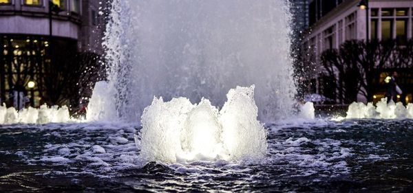 Close-up of fountain in city against sky
