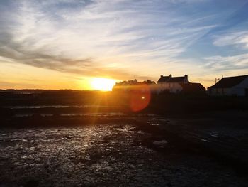 Scenic view of buildings against sky during sunset