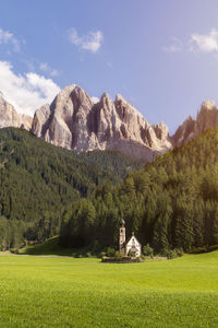 Scenic view of field and mountains against sky