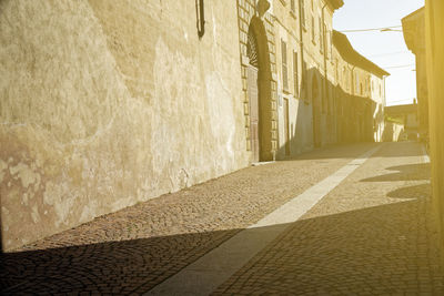 Empty alley amidst buildings in city