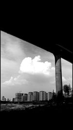 Low angle view of bridge over buildings in city