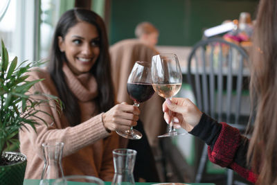 Friends toasting wineglasses in restaurant