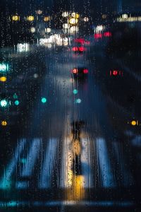 Road seen through wet window during rainy season