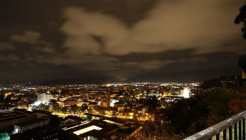 Illuminated cityscape against sky at night