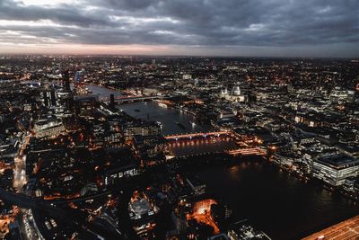 Aerial view of city against cloudy sky