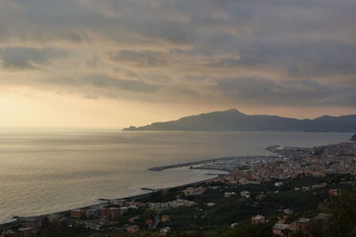 High angle view of townscape by sea against sky