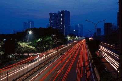 High angle view of light trails on road at night