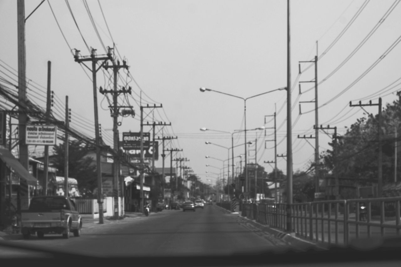 transportation, the way forward, car, diminishing perspective, mode of transport, road, built structure, clear sky, land vehicle, architecture, building exterior, city, street, electricity pylon, power line, vanishing point, sky, road marking, connection, city life