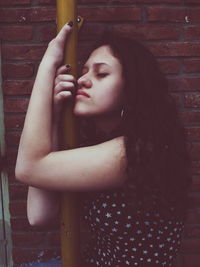 Close-up of beautiful young woman holding leaf