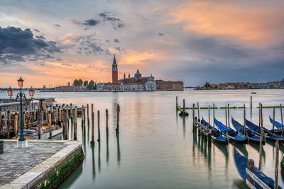 Dramatic sunrise in venice, italy, with some of the traditional gondolas