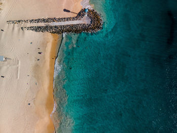 High angle view of deck chairs on beach