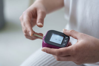 Cropped hand of person holding navigational compass