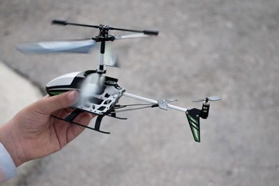 Child playing with radio-controlled helicopter.