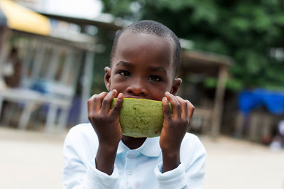 Portrait of boy eating watermelon
