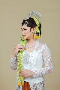 Beautiful model, wearing javanese indonesian wedding dress.