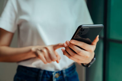 Midsection of man using mobile phone