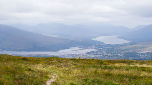 Scenic view of landscape and mountains against sky