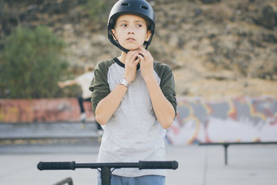 Boy wearing helmet while standing outdoors