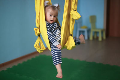 Full length of boy playing on swing