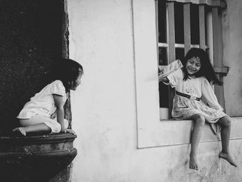 Full length of girl sitting outdoors