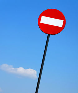 Low angle view of road sign against sky