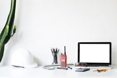 Close-up of laptop on table against white background