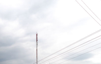 Low angle view of communications tower against sky